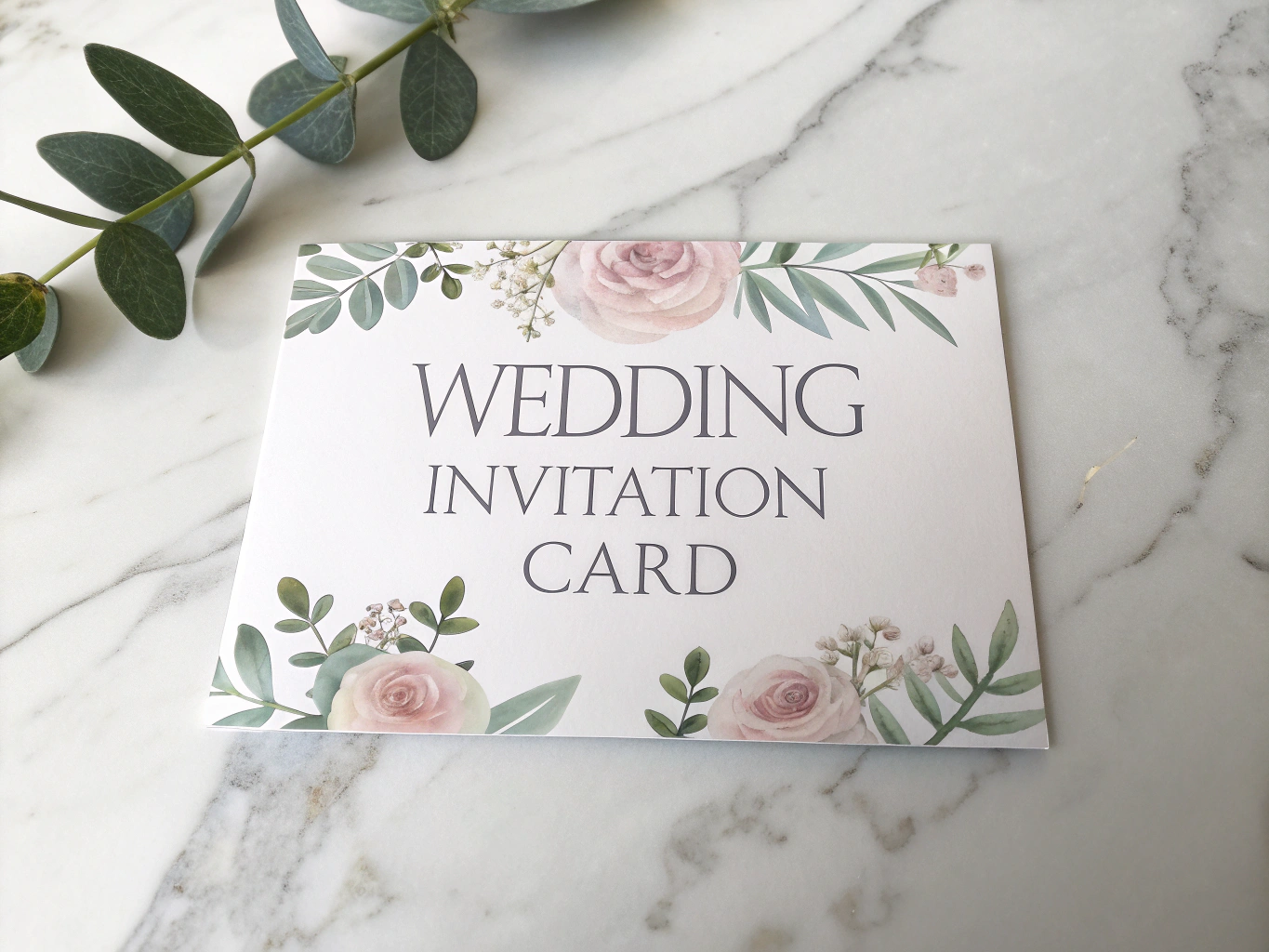 Intricately engraved wedding invitation and table decor